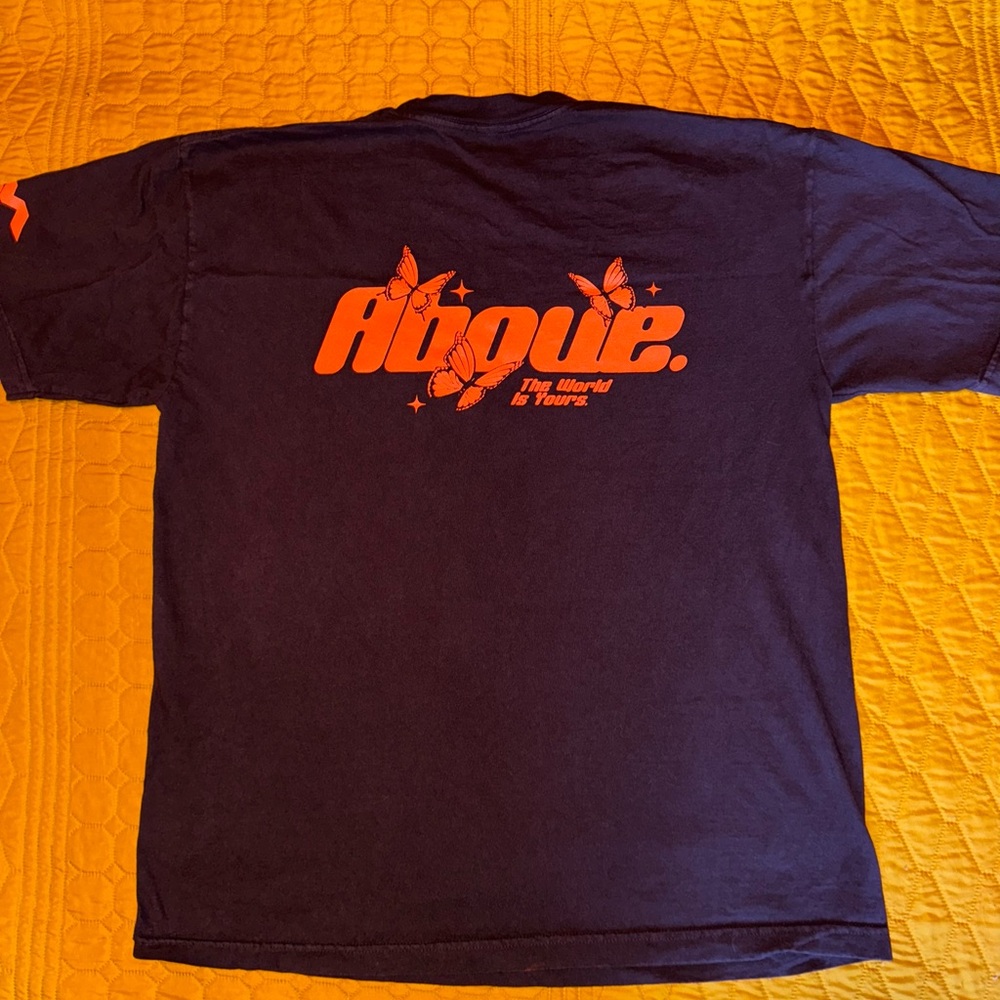Above Millions Tee